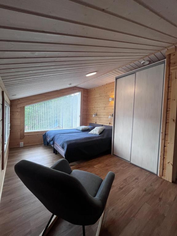 Loft bedroom with a double bed under a sloping wooden ceiling