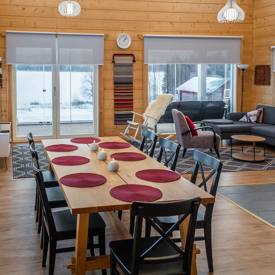 Long dining table beside windows facing the lake