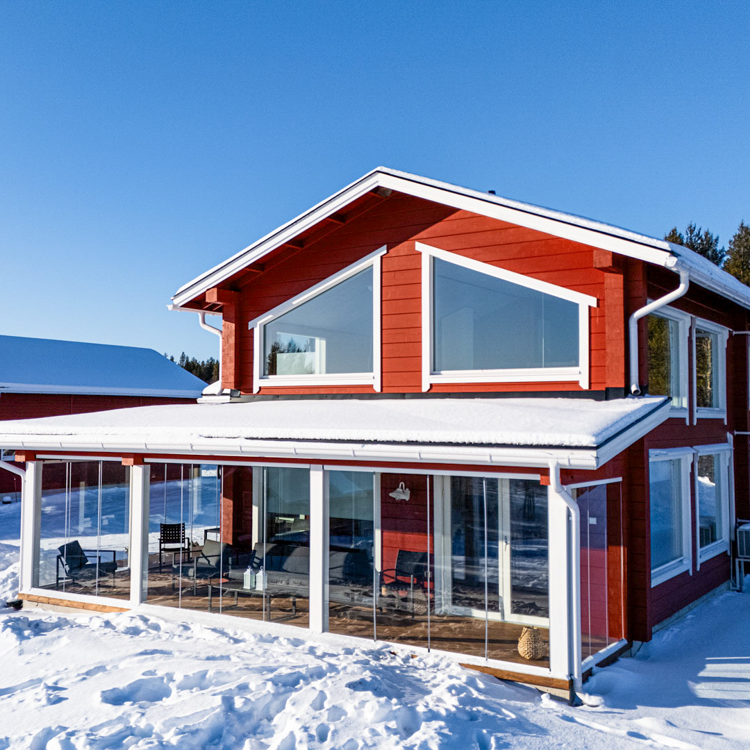 The red villa and its glazed terrace on a clear winter day