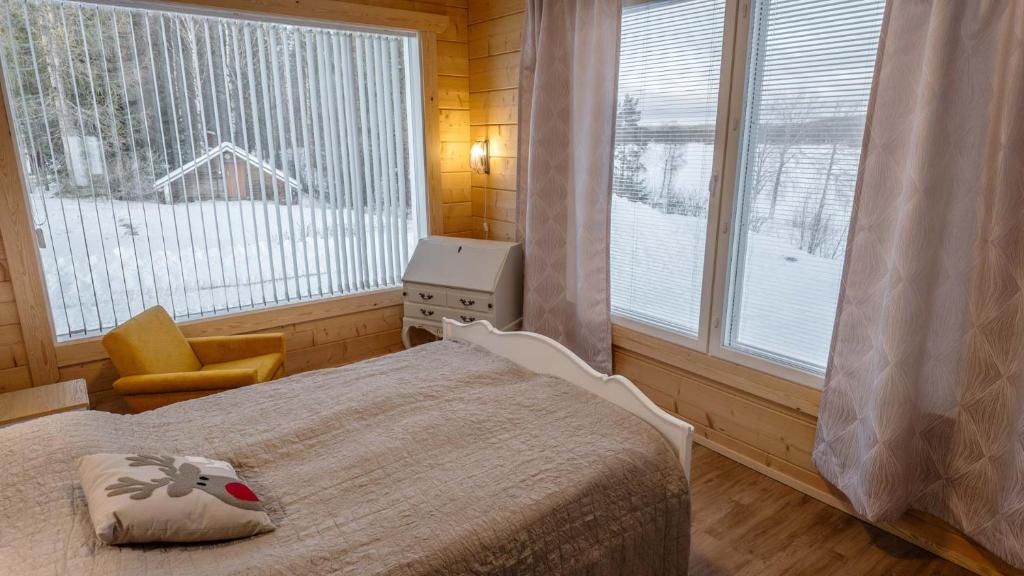 Bedroom with two windows onto the snowy yard